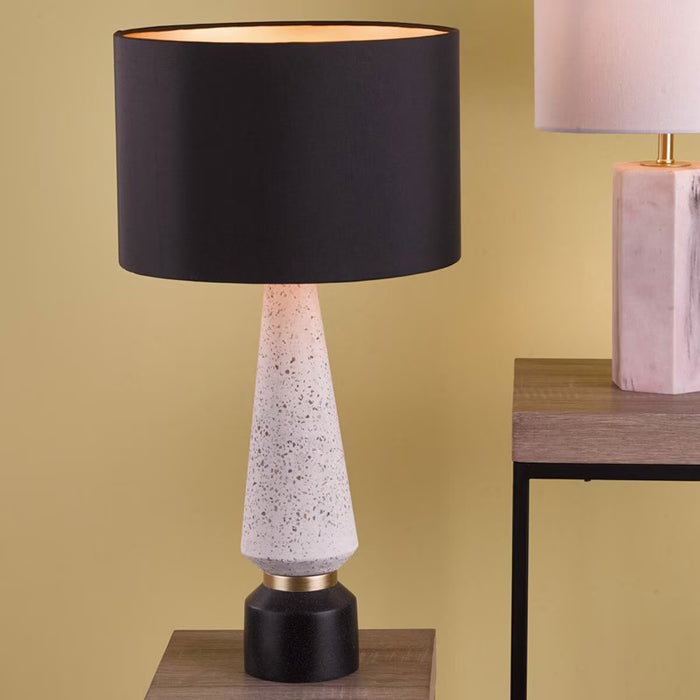 Onora table lamp with terrazzo base featuring black and gold detailing and black faux silk drum shade