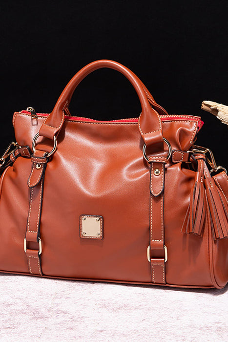 Solid-color PU leather handbag with zipper closure and tassel pendant