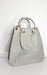 Beige faux leather handbag and shoulder bag set with gold hardware and detachable strap.