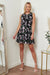 Black floral button-up mini dress in boho skater style.