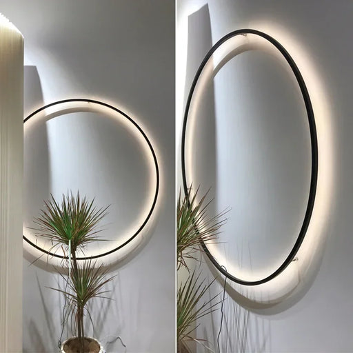 Modern USB-powered LED ring wall lamp mounted on a white interior wall, emitting soft ambient light for bedrooms and living spaces