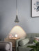 Modern aluminum pendant light hanging over a stylish dining space