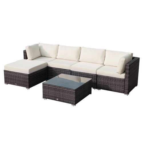  Modular outdoor rattan sofa set with thick cushions and glass-top table in a garden setting