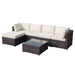  Modular outdoor rattan sofa set with thick cushions and glass-top table in a garden setting