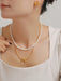 Elegant 3-piece jewelry set with synthetic pearls, gold-plated bow necklace, and titanium steel earrings